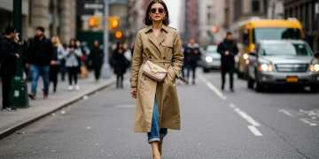 Woman in modern trench coat, city street fashion, reinvented classic style 2025