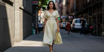 Modern American woman showcasing spring 2025 fashion trends in a vibrant urban environment.