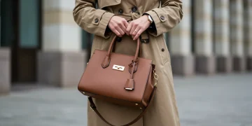 Woman in classic trench coat and leather handbag, epitomizing timeless style