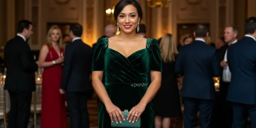 Elegant woman in emerald velvet gown at 2026 social event